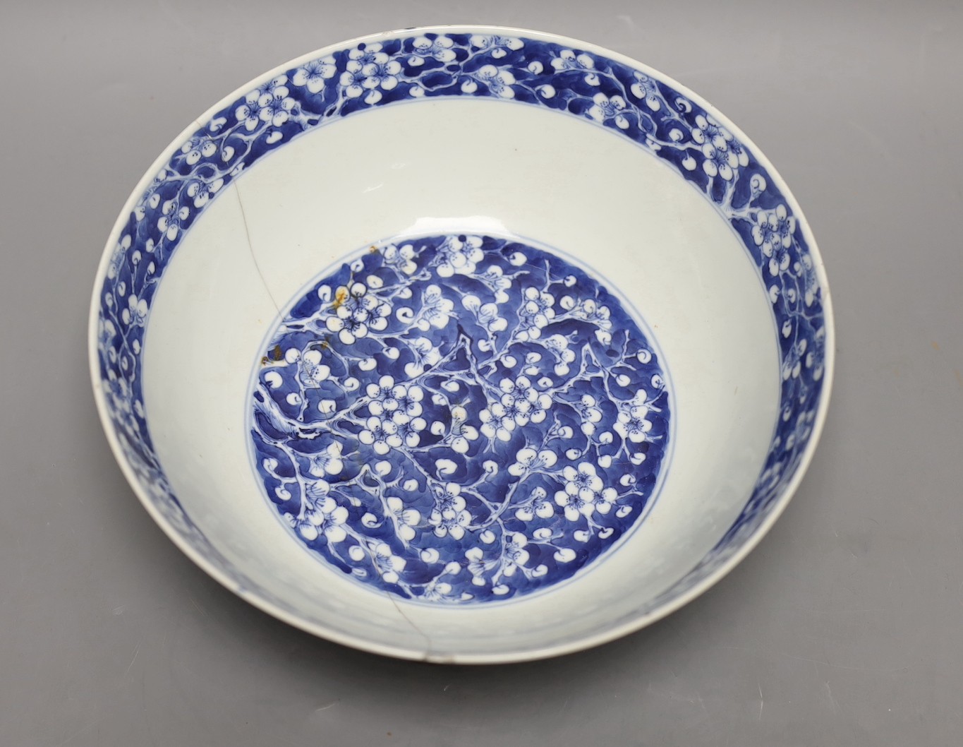 A Chinese blue and white prunus bowl, 19th century. 26.5cm diameter